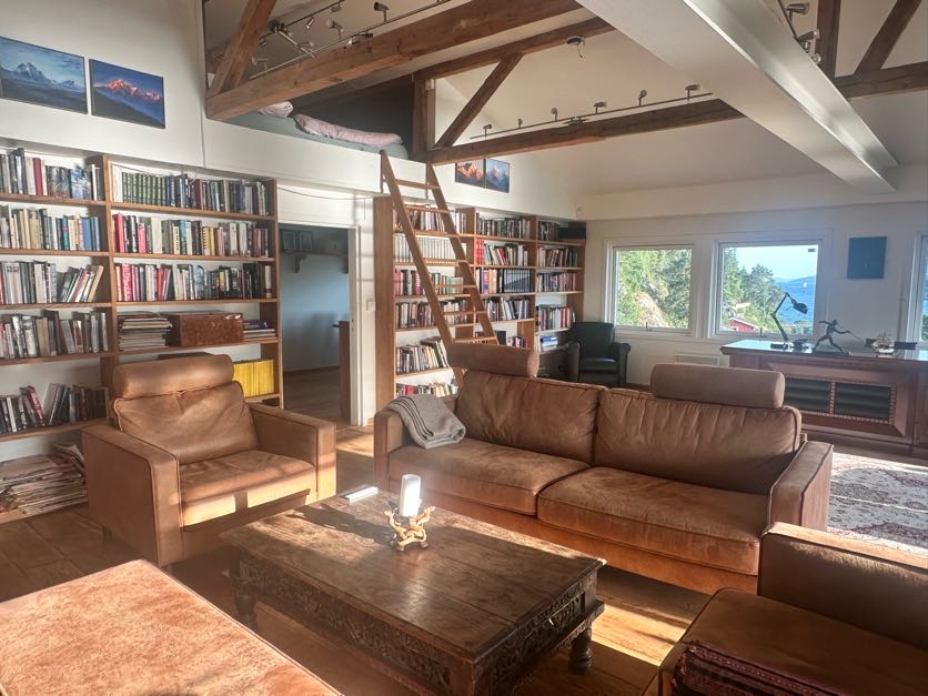 Library lounge with leather sofas under open beams